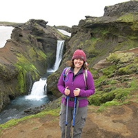 Sarah in Iceland in front of waterfall