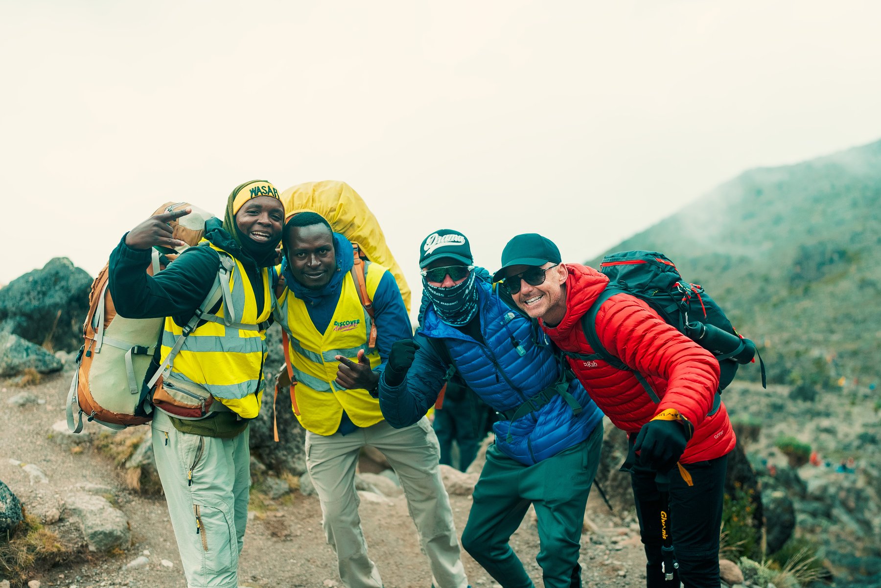 Aitch's Kilimanjaro climb with Discover Adventure - Aitch with Discover Adventure local crew on Kilimanjaro. Credit: Aaron Fitzmaurice
